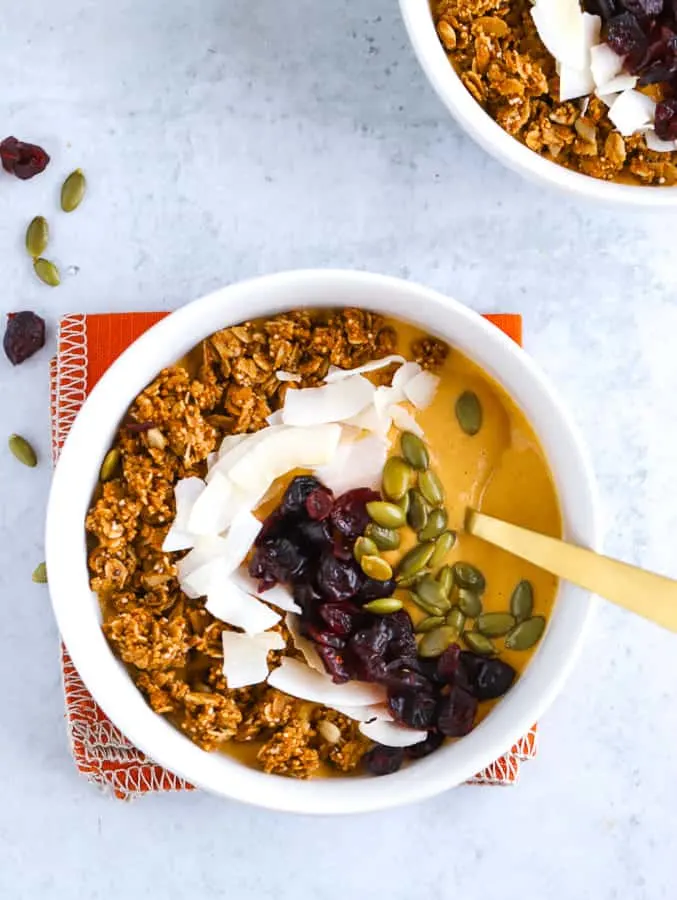 Pumpkin smoothie bowl with Oat Yeah oatmilk in white bowls with orange napkin