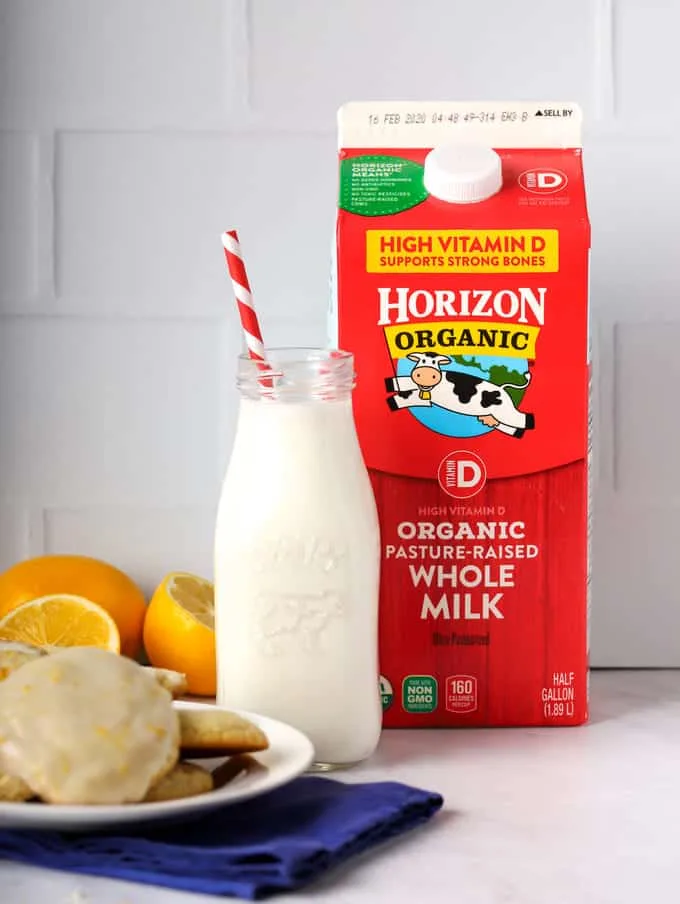 horizon organic milk carton with bottle of milk and red straw and plate of cookies