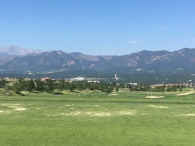 mountain image of blue skies and green pastures