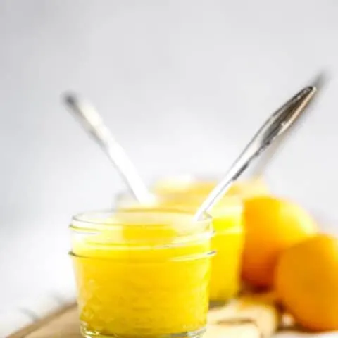 Two jars of lemon curd and meyer lemons