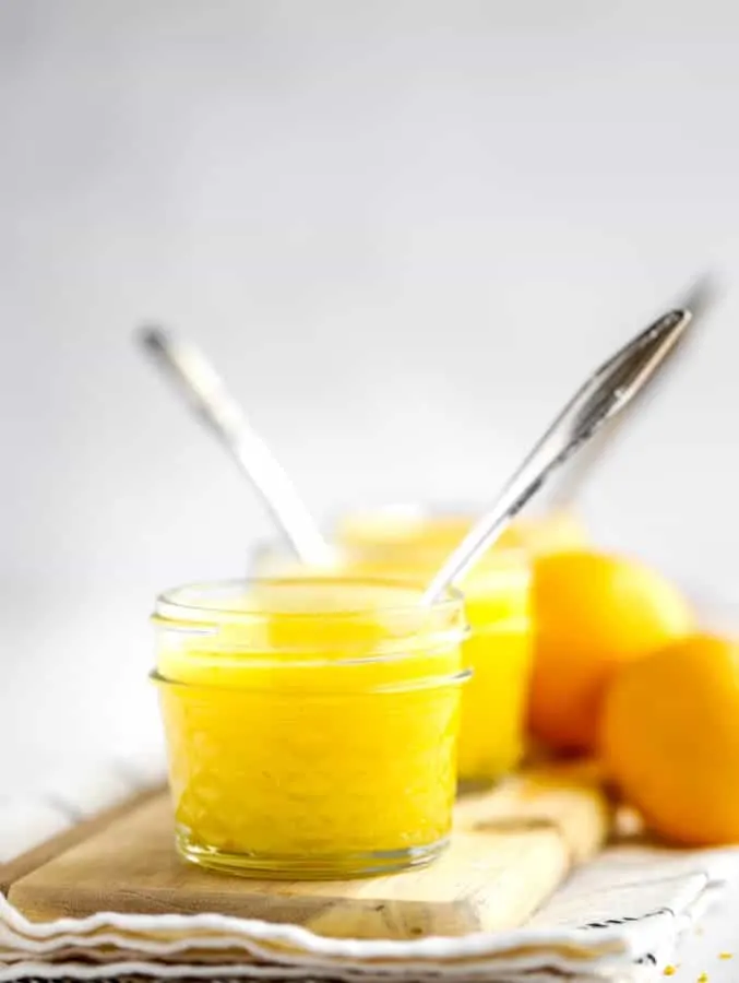 Two jars of lemon curd and meyer lemons