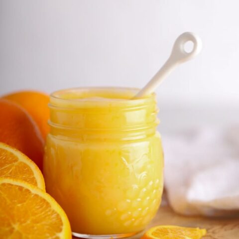 Creamy orange curd on cutting board with white background