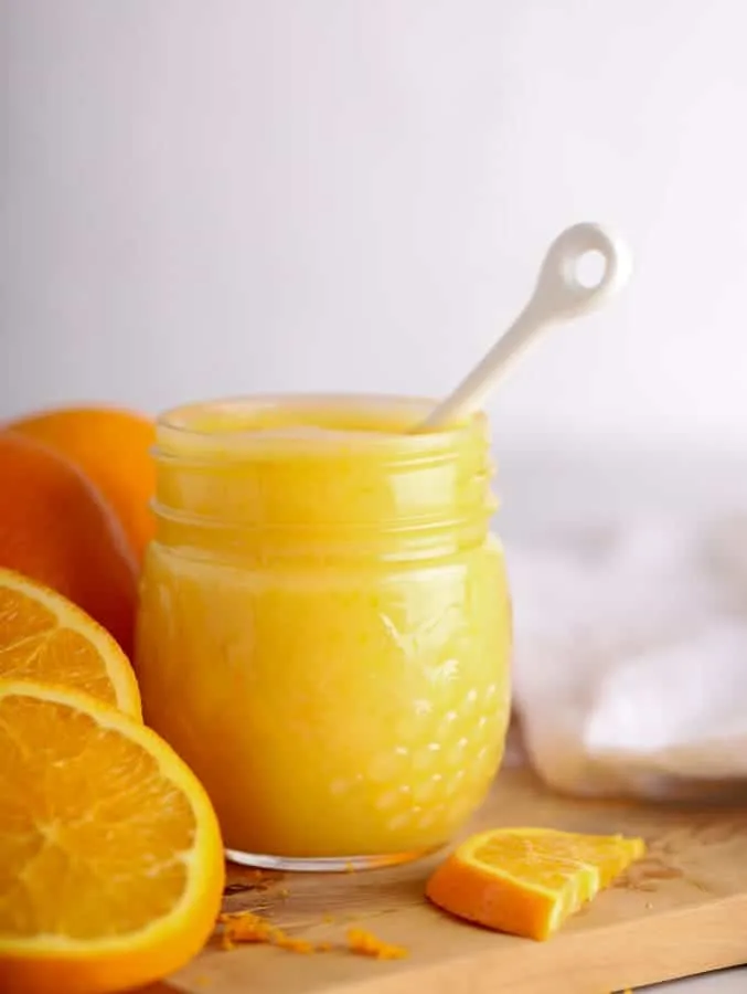 Creamy orange curd on cutting board with white background