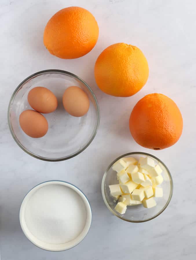 Ingredients for making orange curd of navel oranges, eggs, butter and sugar