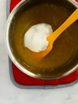 Coconutmilk yogurt alternative with vegan lemon curd and yellow spatula