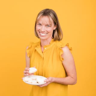 Square photo of Holly Baker with plate of white heart cookies