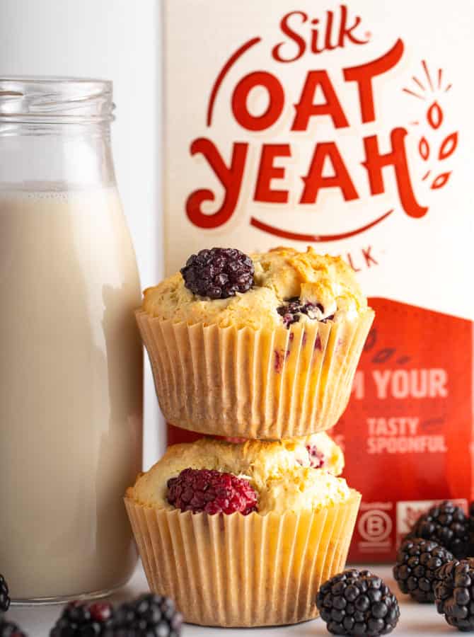 oatYeah oatmilk with two blackberry vegan muffins and glass of oatmilk
