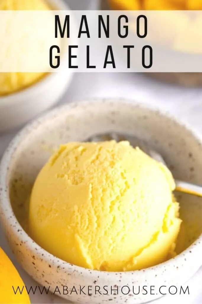 Mango gelato in small bowl with spoon