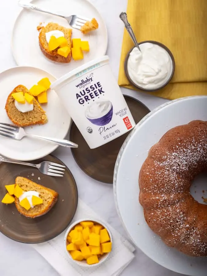 overhead view of Wallaby yogurt and bundt cake with slices of mango cake and mangos