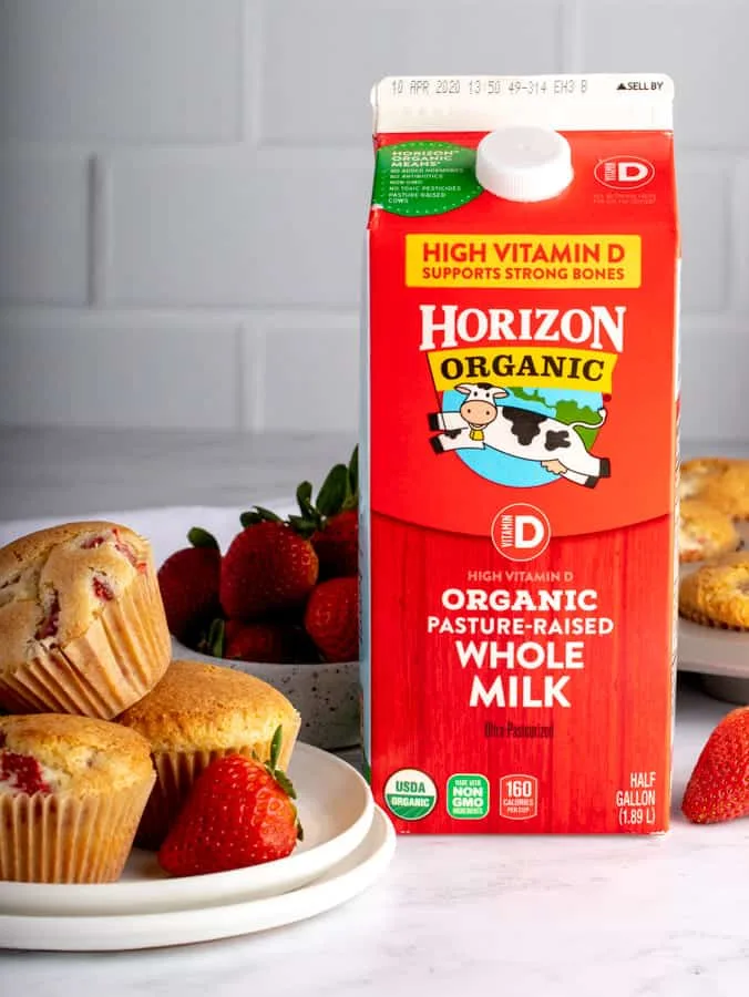 Half Gallon of Horizon Organic Milk on table with plate of muffins and strawberries