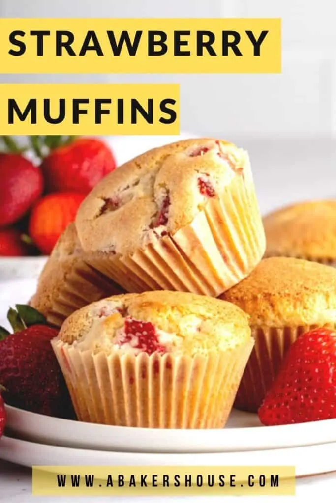 Strawberry muffins in a pile on two white plates