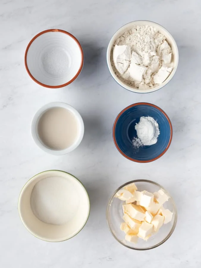 six ingredients in bowls needed to make shortcakes