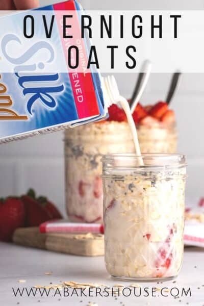 Overnight oats with strawberries in mason jar with Silk almondmilk pouring into the top