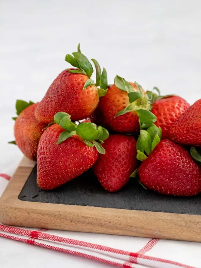 Fresh strawberries on a slate cutting board