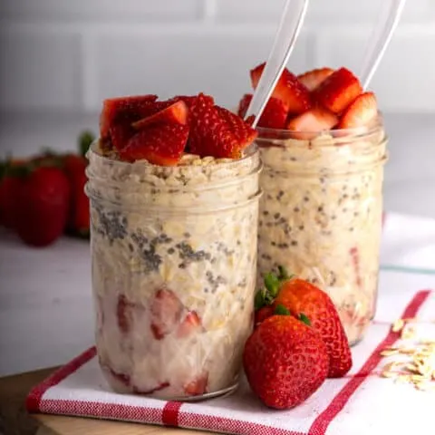 two mason jars of overnight strawberry oats