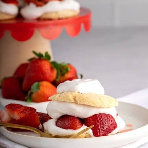 vegan strawberry shortcake on white pottery plate