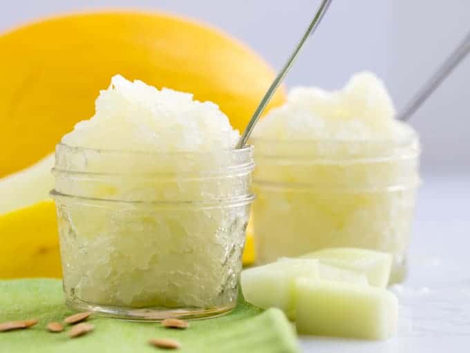 two servings of icy melon granita on green napkin with canary melon in background