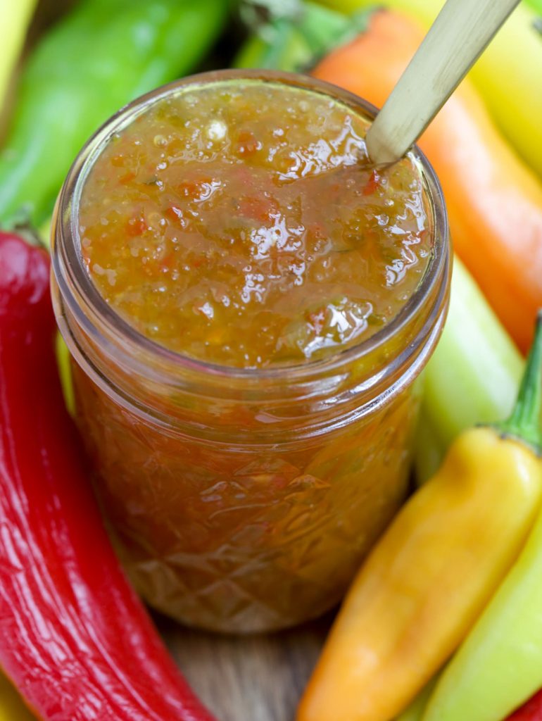 Close up view of an open jar of hot pepper jelly