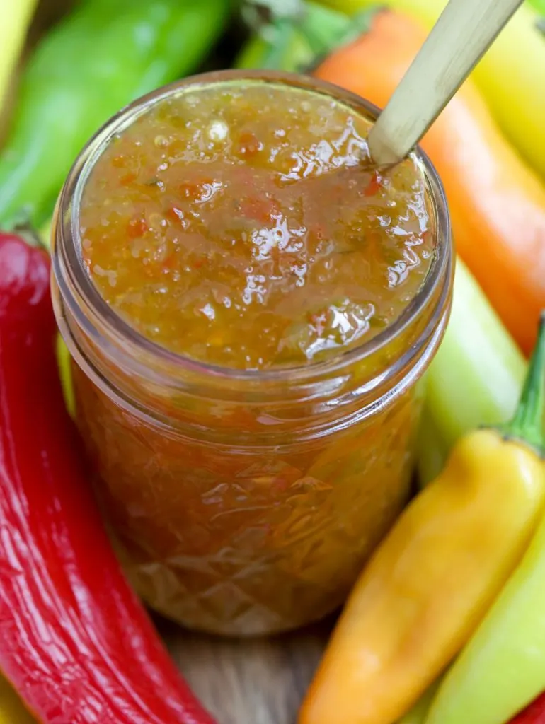 Close up view of an open jar of hot pepper jelly