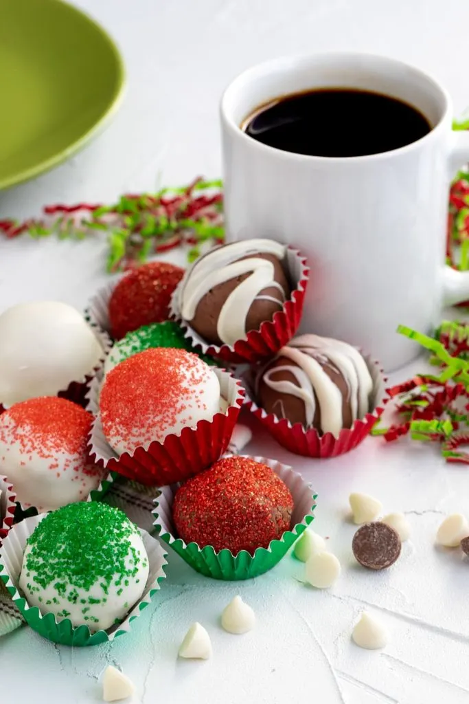 variety of coffee chocolate truffles in baking cups decorated for Christmas in red, green and white
