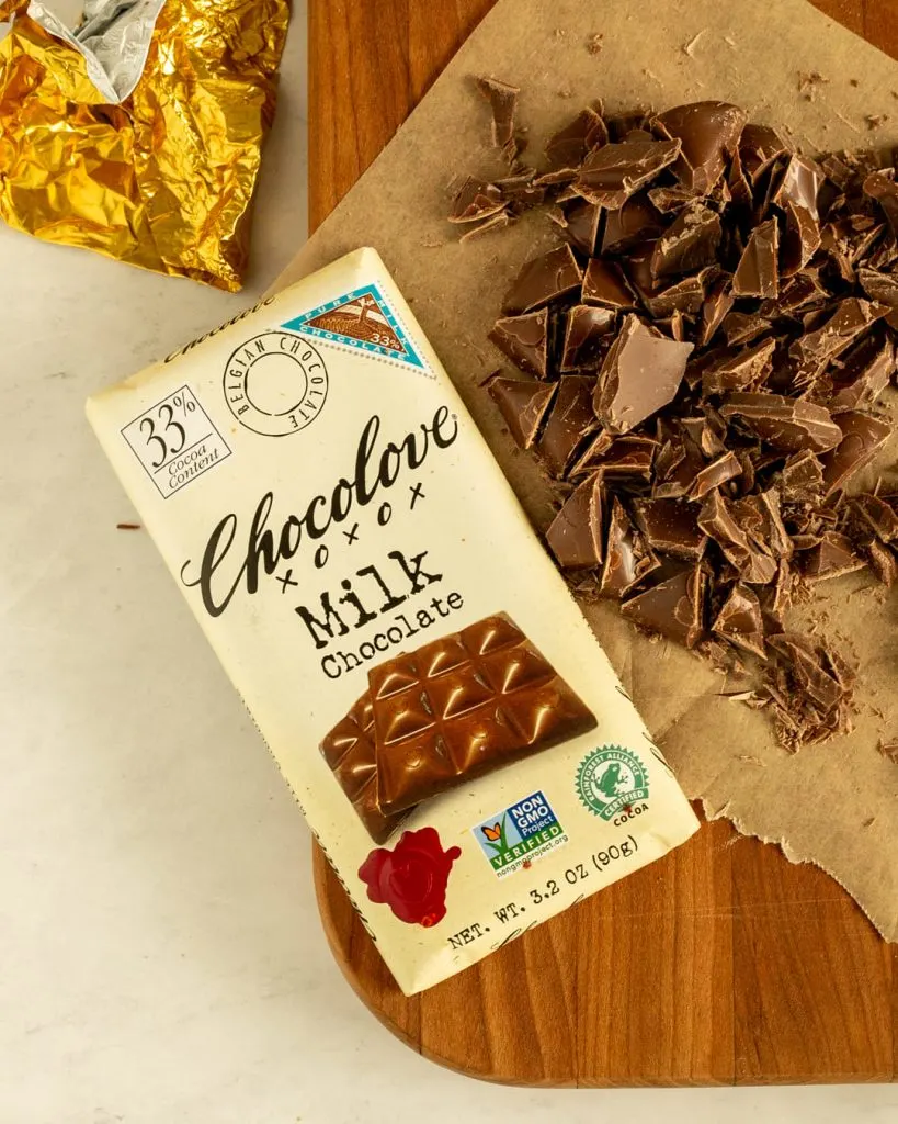 chocolove chocolate milk chocolate bar and chunks of chocolate on cutting board