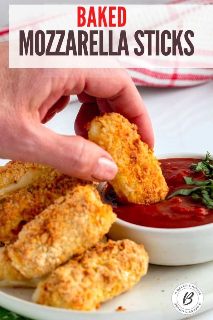 baked mozzarella sticks dipped into marinara sauce