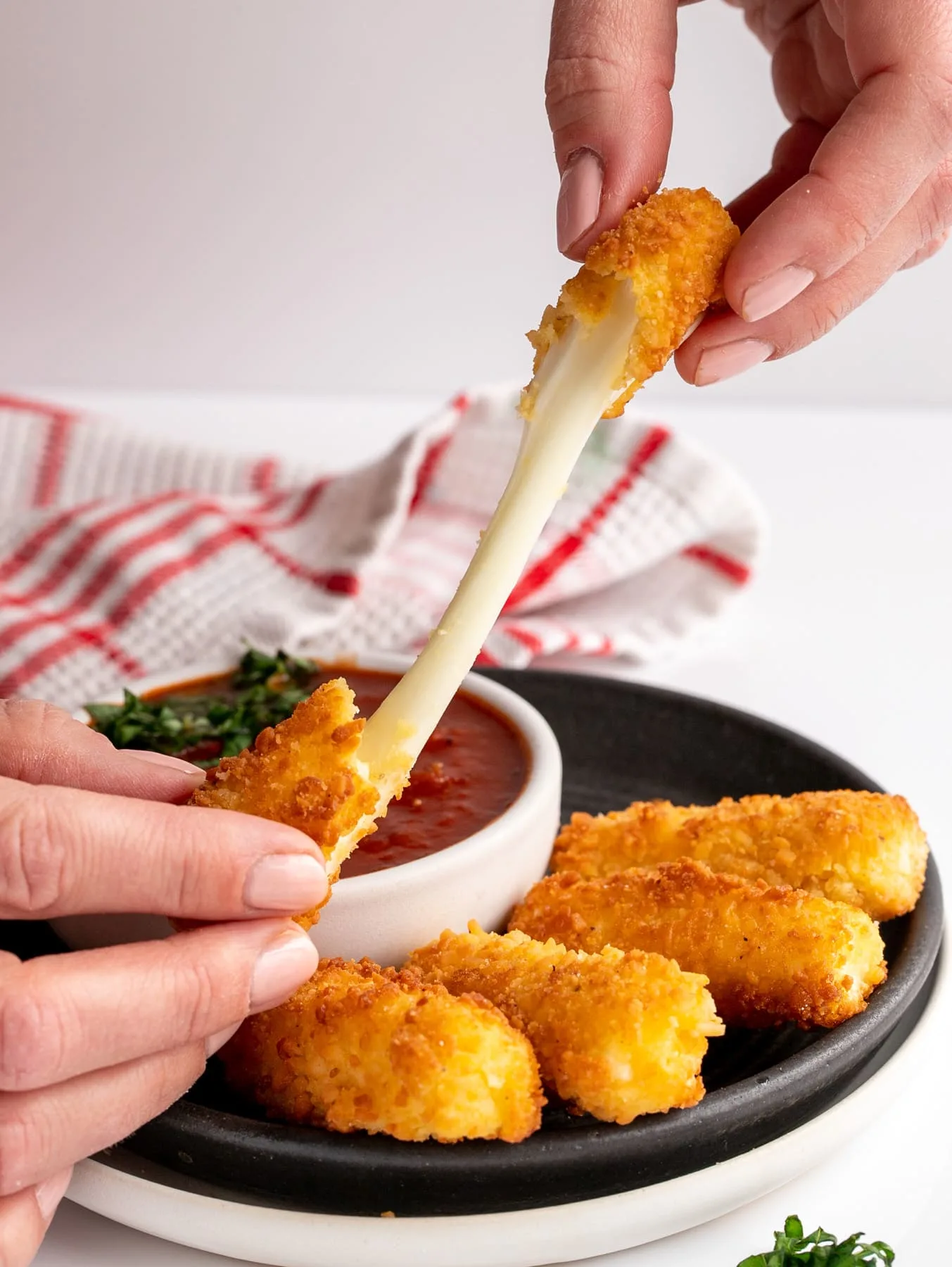 mozzarella stick pulled apart with gooey cheese