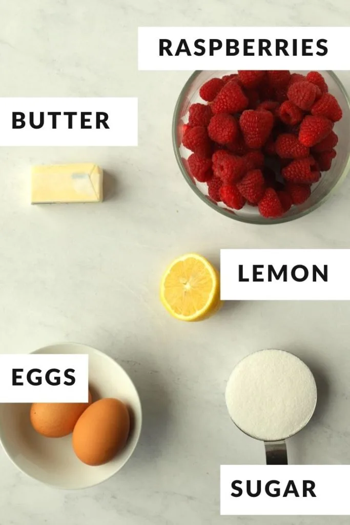 labeled ingredients of sugar, raspberries, butter, and eggs for raspberry curd