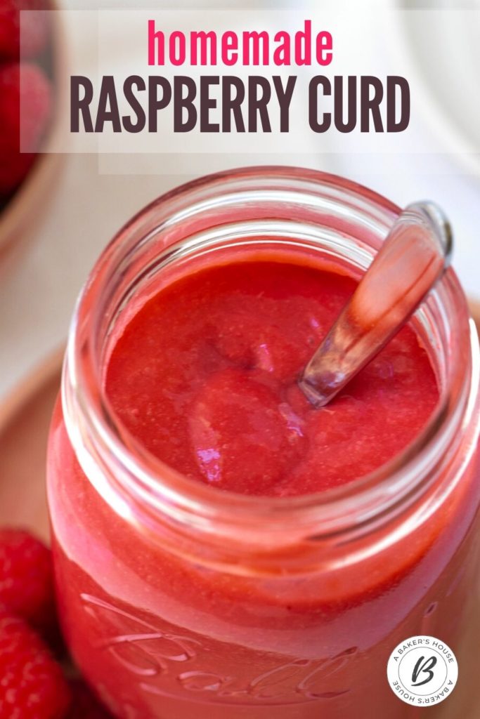 large mason jar filled with raspberry fruit curd and silver spoon