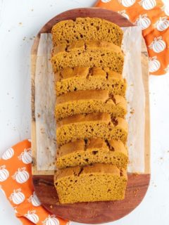 overhead view of sliced pumpkin bread on wood cutting board