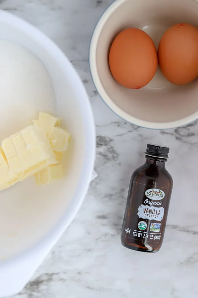 ingredients of butter, eggs and vanilla on marble surface