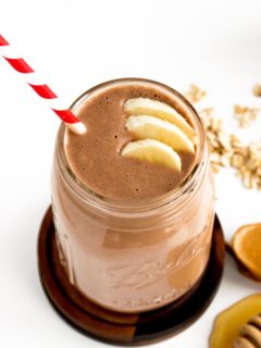 chocolate peanut butter smoothie with bananas and red and white straw