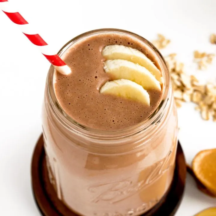 chocolate peanut butter smoothie with bananas and red and white straw