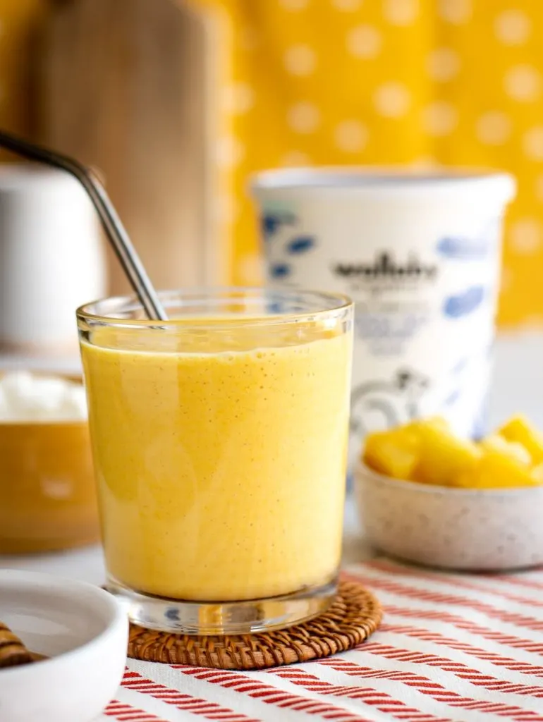 yellow smoothie made with pineapple, mango and turmeric and wallaby Greek yogurt