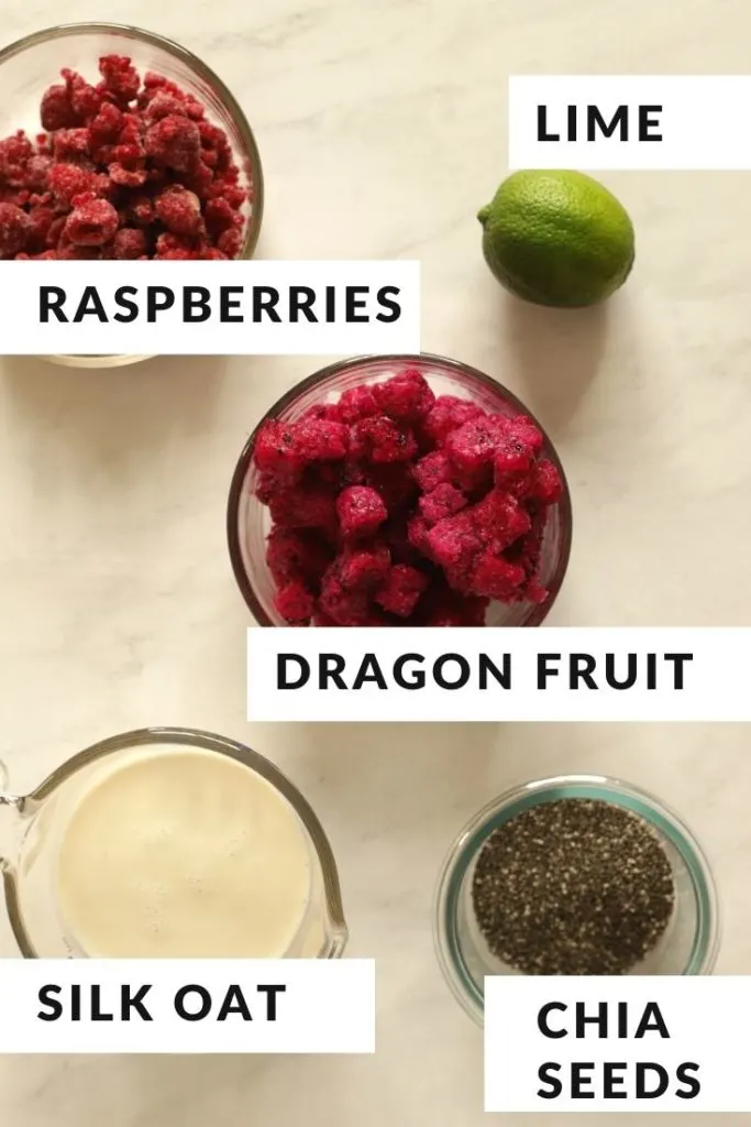 ingredients for smoothie including frozen dragon fruit, silk oatmilk chia seeds lime