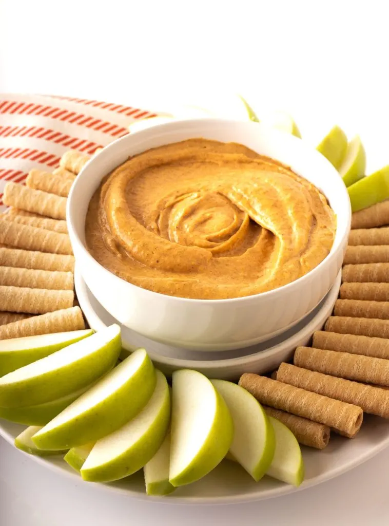 cream cheese pumpkin dip in white bowl with dippers