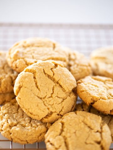 lots of peanut butter cookies on baking rack