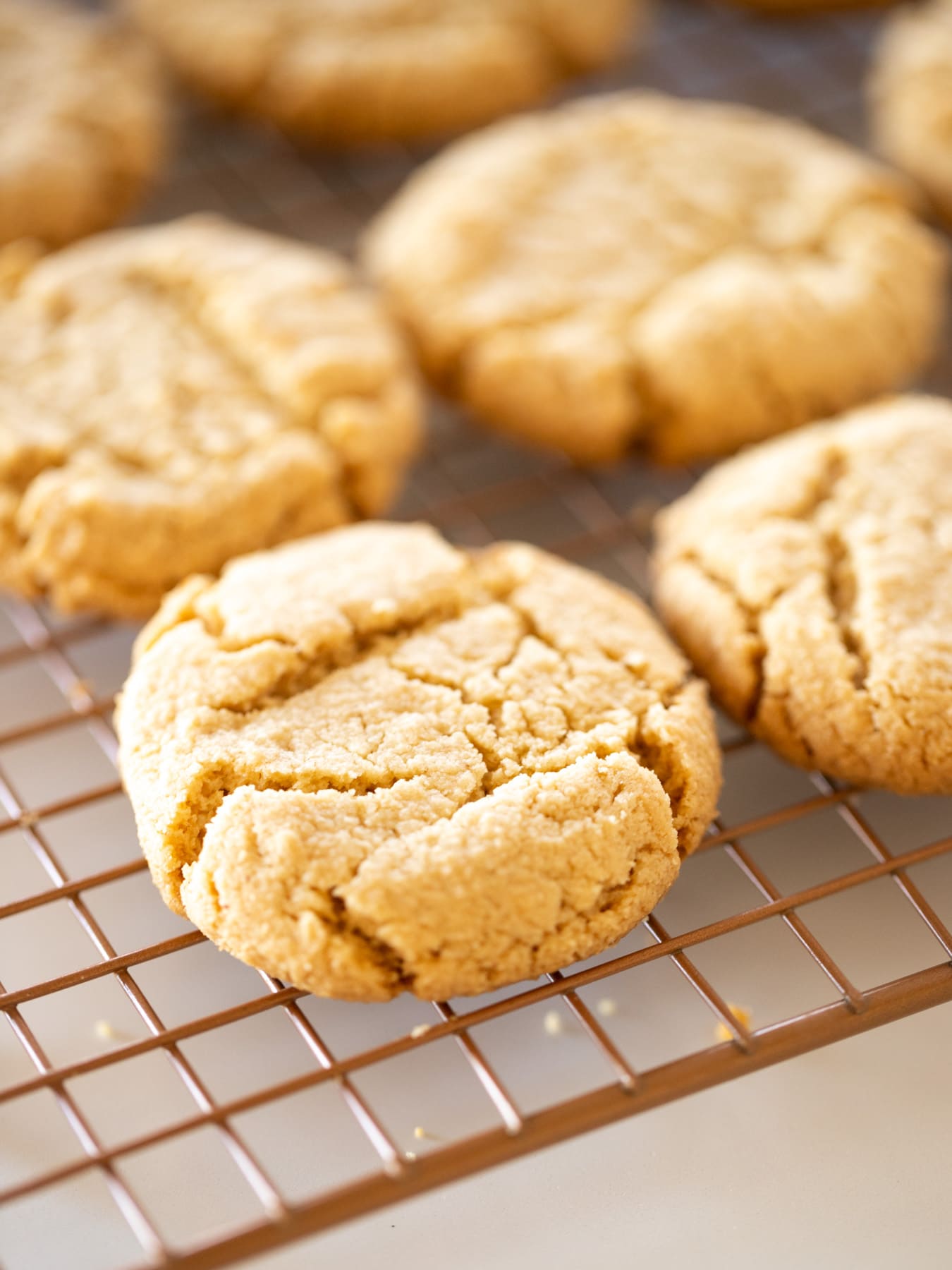 peanut butter cookies on wire cooling rack on white counter